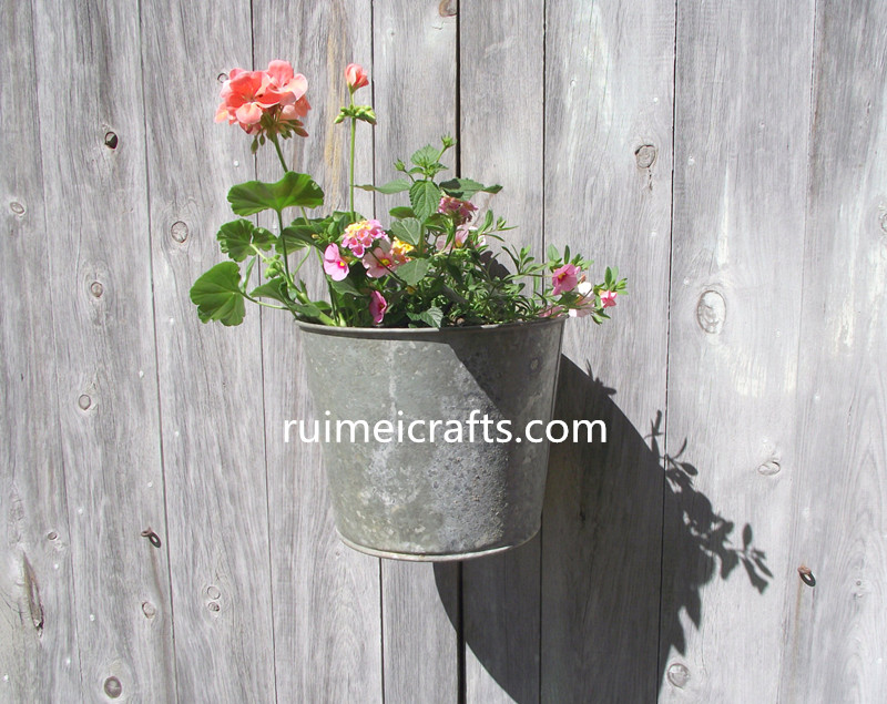 rust metal wall hanging flower pot.jpg